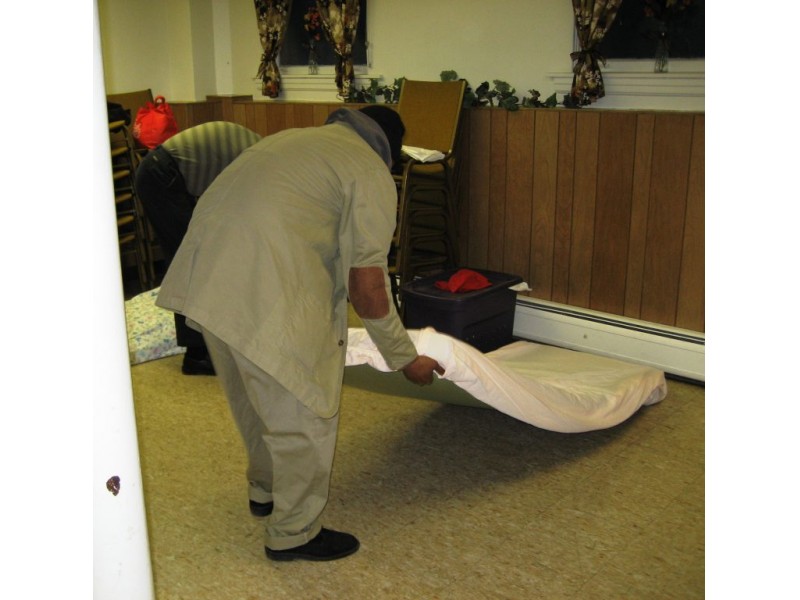A man prepares his bed at the BEDS program location in Western Springs. Credit: Western Springs Patch (2011)