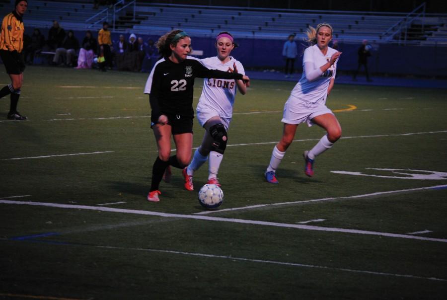 Kristen Janicki'15 attempts to steal the ball from a York player, while Izy Scott stands around and does nothing