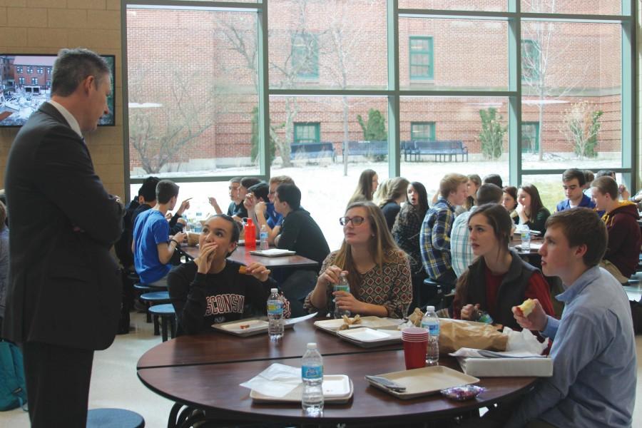 Principal Brian Waterman converses with a group of seniors in the new lunch room on March 27.