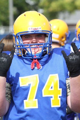 Junior marches on sideline, rushes on field