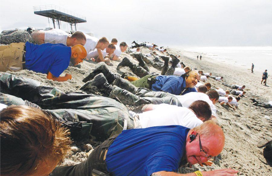 Several security guards get wet and sandy in exercise off the coast of California.