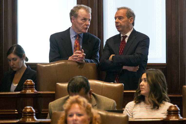 House Speaker Michael Madigan, D-Chicago, left, and Senate President John Cullerton, D-Chicago, talk on the Senate floor Tuesday, July 4, 2017, at the Capitol in Springfield, Ill. The Illinois Senate has OK'd an annual spending plan of $36 billion following a critical vote to raise the income tax rate. If approved by Republican Gov. Bruce Rauner, it would be Illinois' first budget in more than two years. (Rich Saal/The State Journal-Register via AP) 