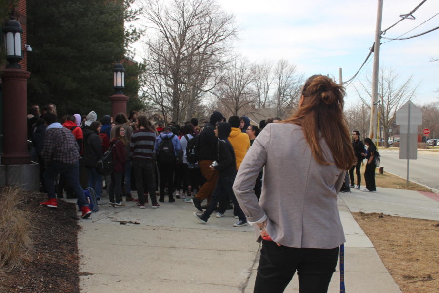 LT administrator looks on as students demonstrate.