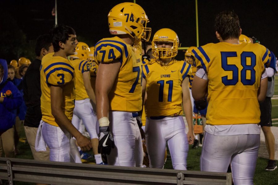 Jack Denning 19 and JJ Dutton 19 prepare on sideline prior to game against Carl Sandburg High School. On Tuesday, LT students and community members had the chance to meet the new LT Football coach, Dan Hartman (Sorice/LION).