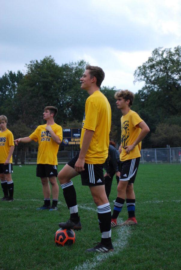 Ty Williams holds a ball during a soccer scrimmage