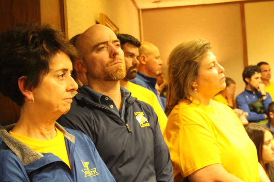 Teachers watch the school board meeting on Nov. 16.