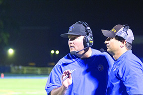 : Head coach Dan Hartman (LEFT) strategizes with defensive coordinator, Carl Landi (RIGHT) during the second quarter (Sorice/LION)