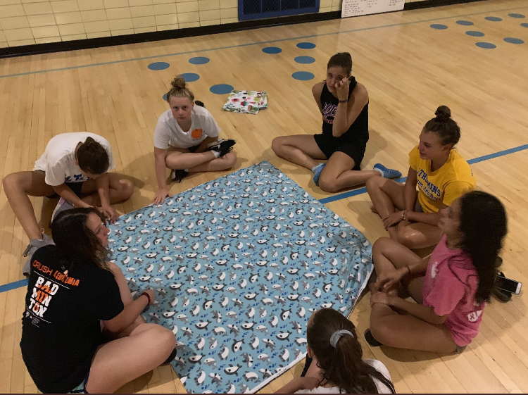 Cerys Egan ‘20 and teammates create blankets for sick children in hospitals through Project Linus after one morning practice (photo courtesy of Coach Erin Rodriguez).