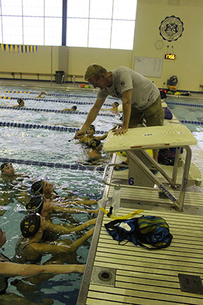 Coach Scott Walker instructs swimmers to complete a set during after school practice in the SC pool (Sorice/LION)