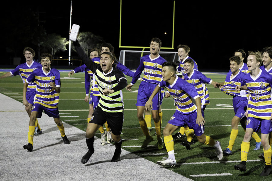 The varsity team ecstatically ran off the field to celebrate with their fans after winning the Silver Brick against Hinsdale Central on Sept. 26 (courtesy of Anthony Fertitta). 