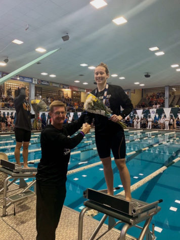 Cal Dunn '20 shakes coach Scott Walker's hand after her first place win on Nov. 23 (photo courtesy of Erin Rodriguez).