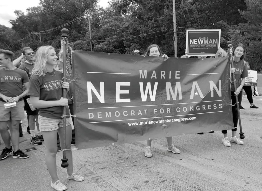 Students Sophia Tarasuk (pictured to the left of the banner) and Jaden Ownby (pictured to the right of the banner) walk for Marie Newmans campaign (courtesy of Ownby). 