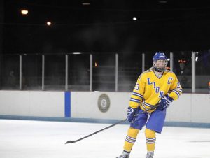 Aidan Sheehan '20 skates across ice on the Bobby Hull Community Ice Rink (photo courtesy of Jelena Cejka). 