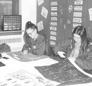 Students work on collages about the history of fashion during class (Shearill/LION). 
