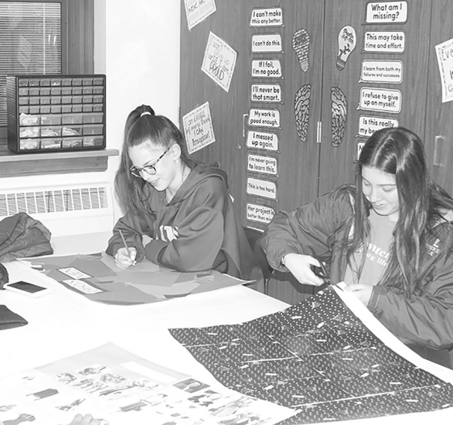 Students work on collages about the history of fashion during class (Shearill/LION). 