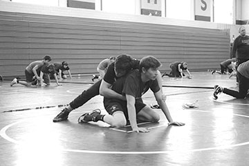 Andrew Schodrof 20 (LEFT) attempts to pin Paul Cozzi 21 (RIGHT) during a drill at practice on Jan. 21 (Riordan/LION)