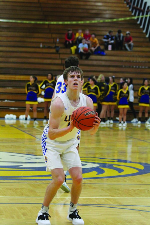 Grant Niego 20 shoots a free throw  against Oak Park River Forest High School in the  NC fieldhouse (Sorice/LION).