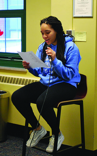 Student reads her work during Open Mic Cafe 