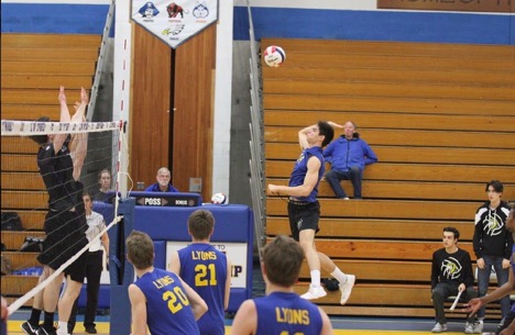 Right-side hitter Miki Dubak ‘20 jumps for the spike against Leyden High School in the NC fieldhouse on May 2, 2019.