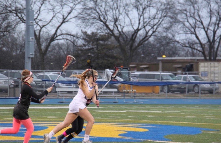 Elise Husemann 20 and teammate play against Wheaten-Warrenville South (courtesy of Husemann).  