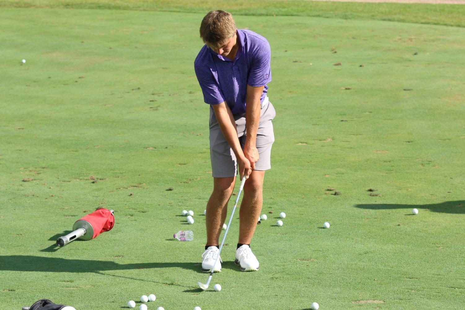 Varsity golfer Griffin Pohl 21 takes some shots on at the fairway at a practice. (Tiernan Kelly/TAB) 