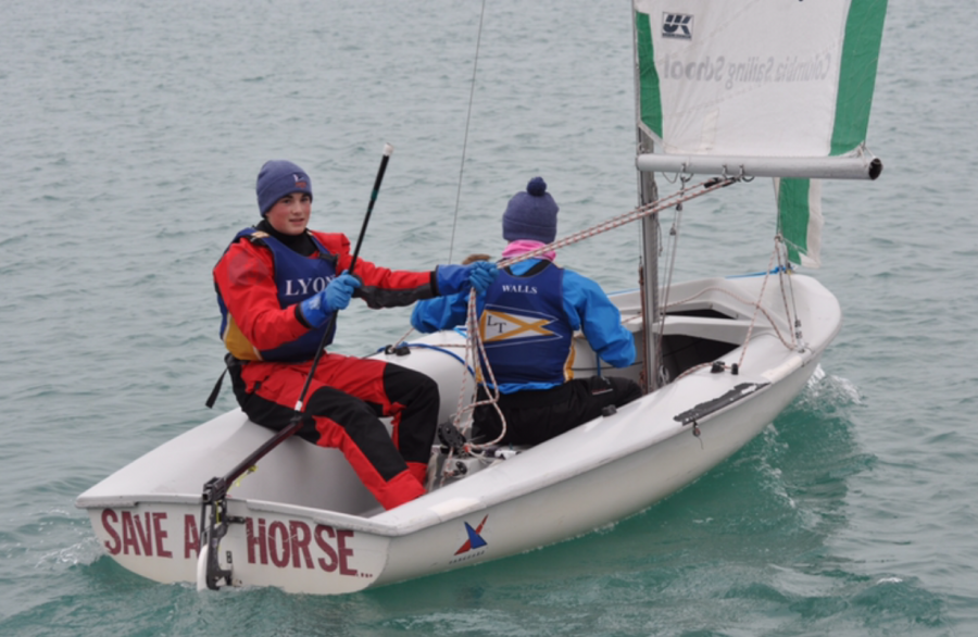 Gavin Dempsey ‘22 (left) and Aidan Walls ‘21 prepare their boat before a race (photo credit Dempsey)
