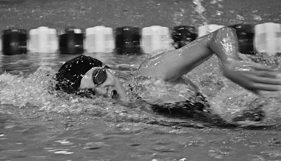 Emily Claesson swims at a meet between Lyons Township at Hinsdale Central during her time at LT (photo courtesy of Claesson).