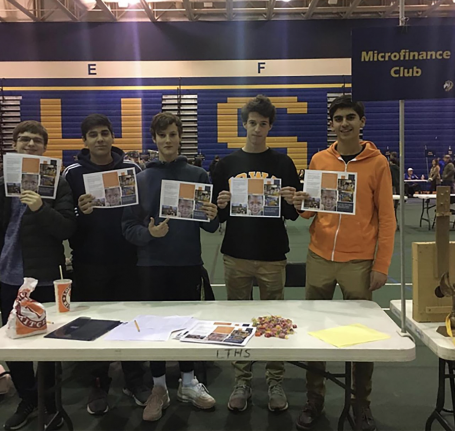 Club members hold up flyers showing details of club (photo courtesy of Hojjat).