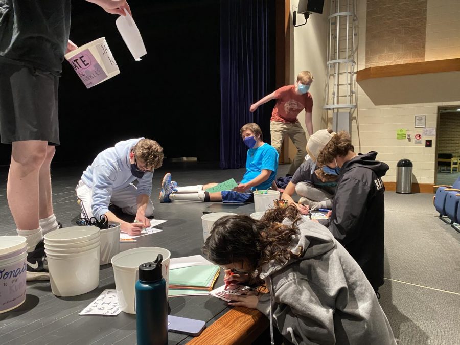 Mr. LT participants decorating buckets to collect donations 