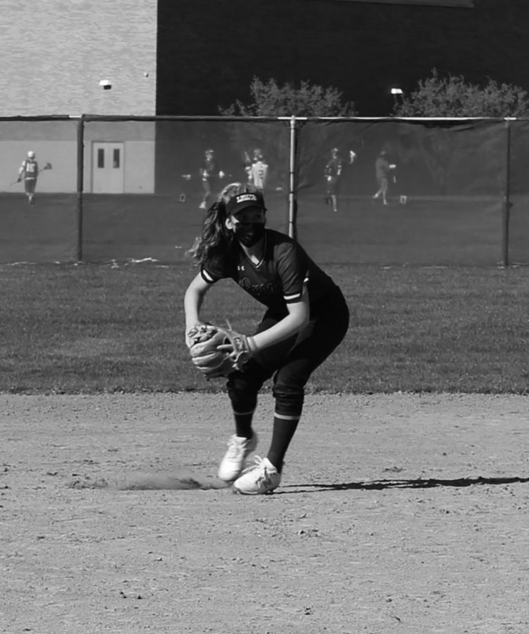 Ava Paganis 22 prepares to make a throw during an infield drill at practice on April 12 at the South Campus varsity softball field (Dike/LION).