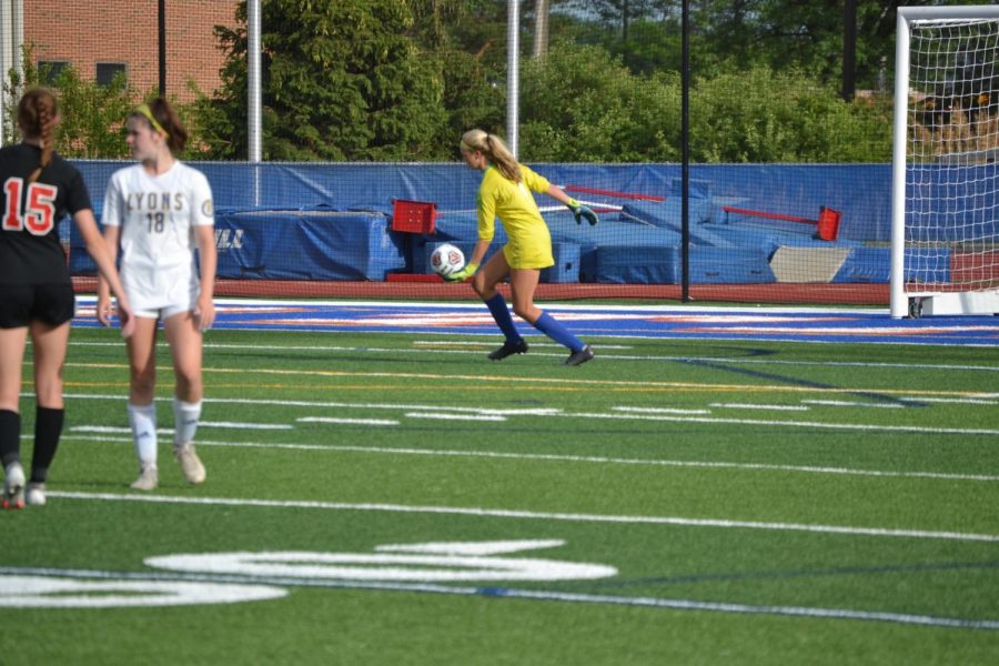 Goalie Izzy Lee 22 goes to punt the ball.