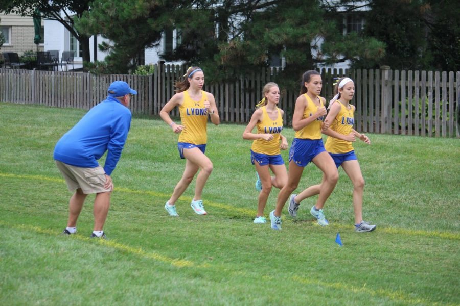 Eric Simon coaches team at home meet (Wolf/LION). 