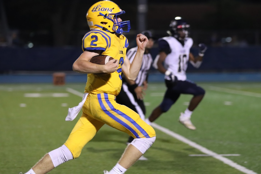 Aidan Sullivan rushes for a touchdown on Friday to put the Lions up by 49 (Photo by Jackie Clifton). 