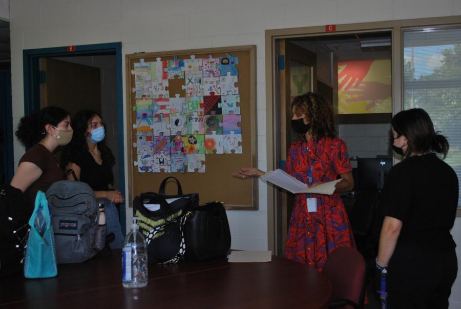 From left to right: Angelica Borrego 22, Janessa Mosqueda 22, Jennifer Rowe, and Ibet Herrera meet in B101 to discuss care space (Quealy/LION).