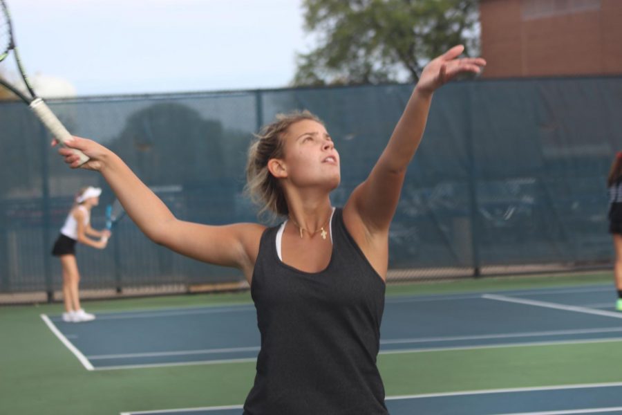 Varsity tennis player Anastasia Bozovic 22 prepares to serve tennis ball at opponent at home sectional match at Oct. 15 (Burke/LION)