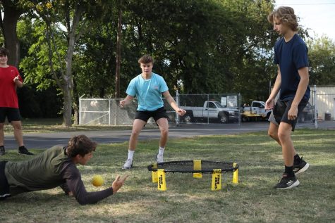 Michael Patera 23, on the right, Ryan Johnson 23, in the middle, and Chase OBrien 23, diving, play Spikeball earlier this semester (photo courtesy of Grace Geraghty).