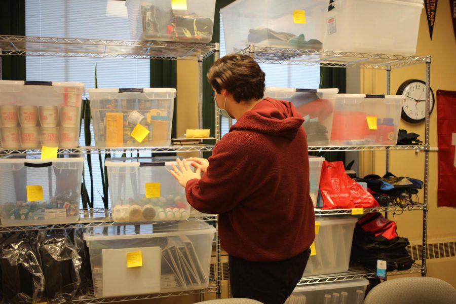 Student organizes non-perishable foods, school supplies at NC Care Space in the College/Career Center (Quealy/LION).