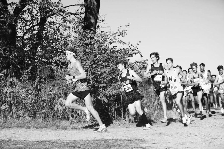 Finn Gallagher '22 (second from left), Hayden Constas (third from left) make a turn at 2021 cross country meet (photo courtesy of Constas). 