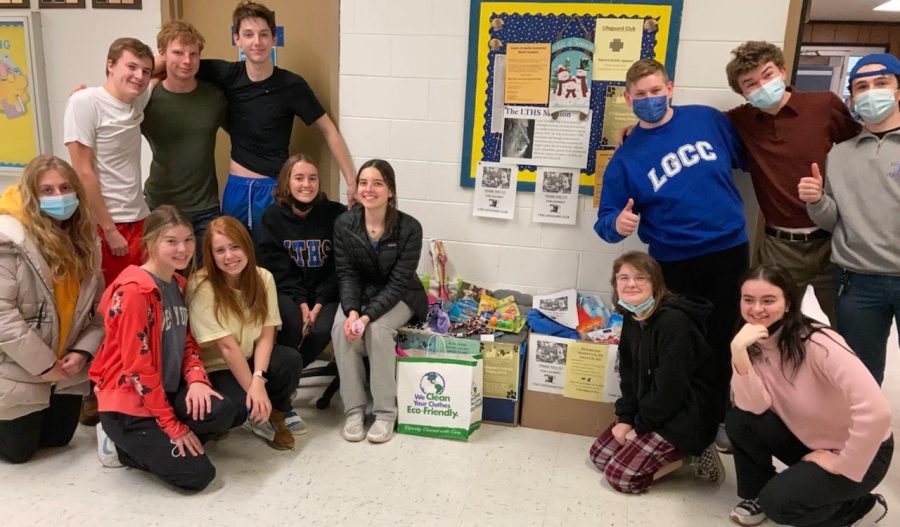 Photo courtesy of Patricia Devitt) Lifeguard Club members met on 1/20, seen next to donation bins 
