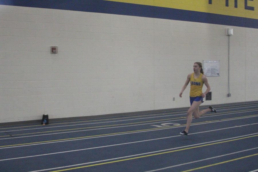Becky Phillips 23 runs 200 meter race at home quad meet on March 12 (Chomko/LION).