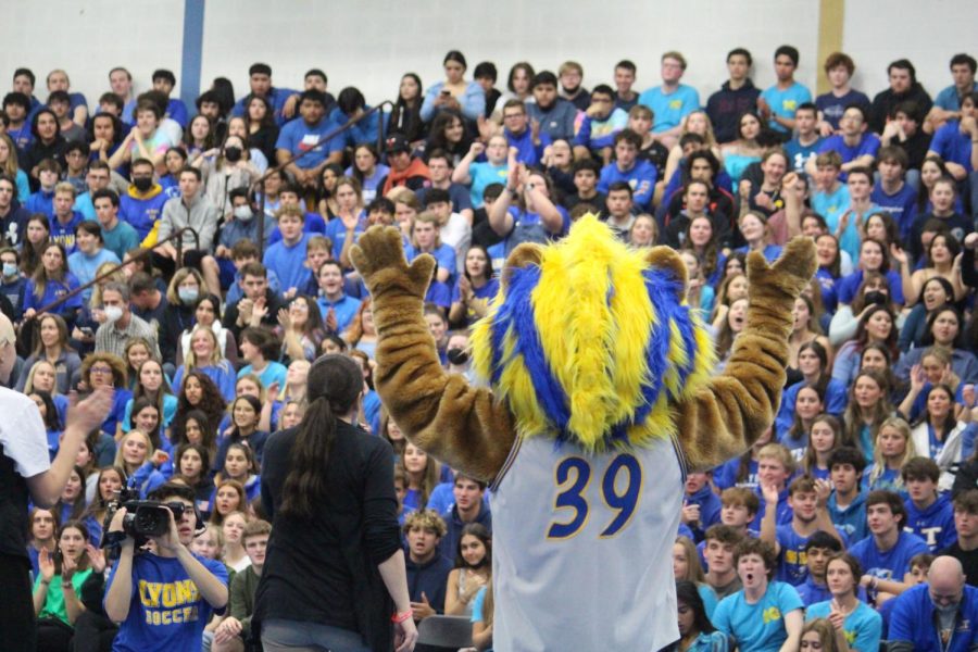 Principal Jennifer Tyrrell and mascot Noil close out All-school assembly (Wolf/LION). 