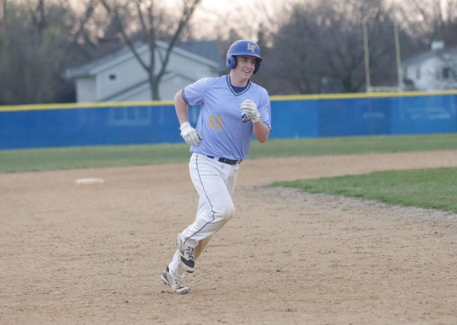 Jack MacNamara 22 rounds bases after home run against Downers Grove North on April 11 (photo courtesy of Mark Viniard). 