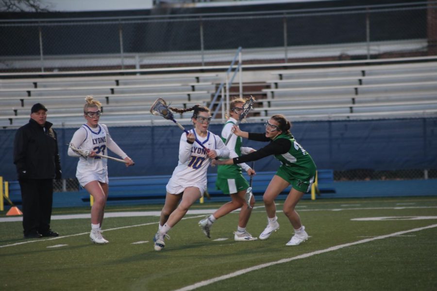 Ryan Maley 22 makes a breakaway move towards goal at home game against York High School on April 14 (Wolf/LION).