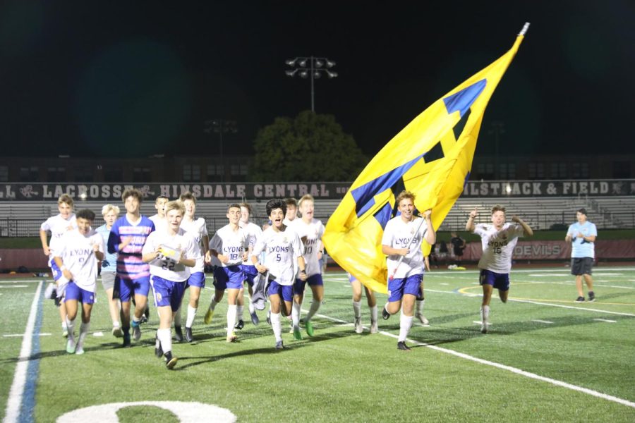 Igor Chrobotowicz 23 leads team in celebration over Hinsdale Central on Sept. 20 (Wolf/LION).