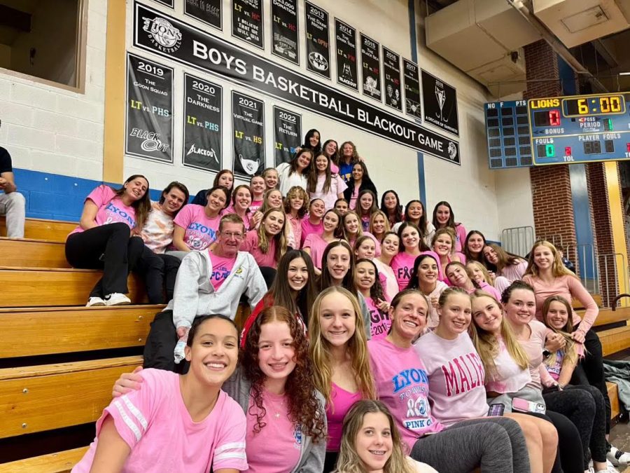 Girls+swim+and+dive+team+supports+girls+volleyball+at+their+annual+Pinkout+Game+on+Sept.+27+against+OPRF+%28photo+courtesy+of+Erin+Rodriguez%29.