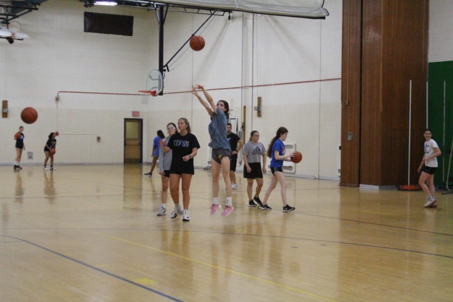 Ally Cesarini 23 shoots basketball as Kennedy Wanless 24 waits to shoot behind her at practice on oct/ 13 (Davis/LION),