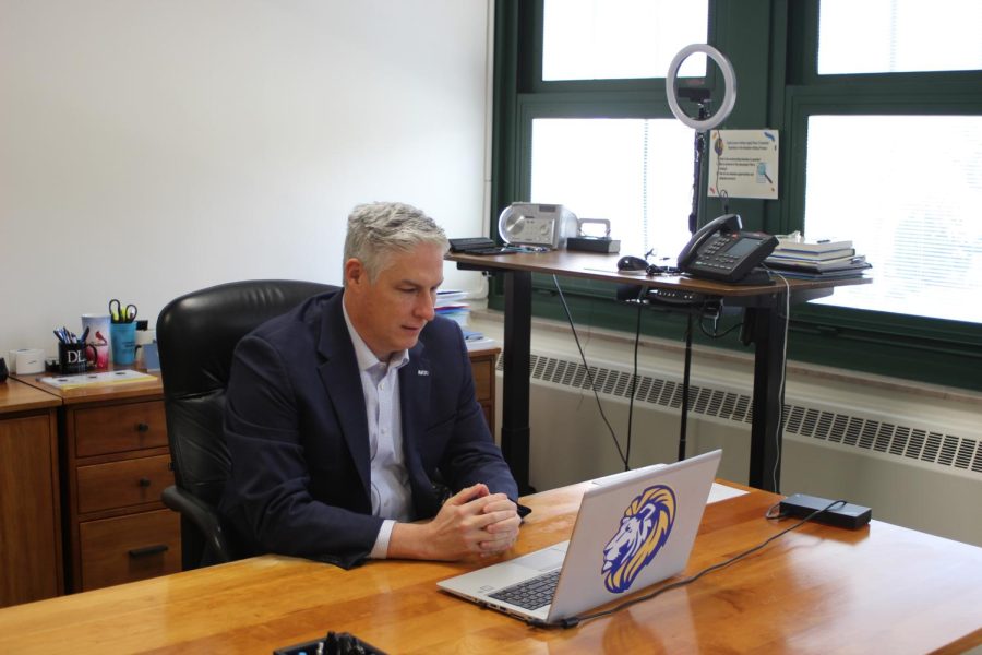 Superintendent Brian Waterman sits in front of his computer on Dec. 5 during period 5A in his office where he does Word with Waterman (Barbera/LION).