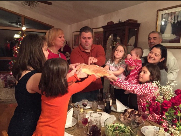 +Kathryn+Lazich+%E2%80%9823+and+her+family+breaking+the+bread+%28cesnica%29+for+Orthodox+Christmas+on+Jan.+7+in+2015+%28photo+courtesy+of+Lazich%29.