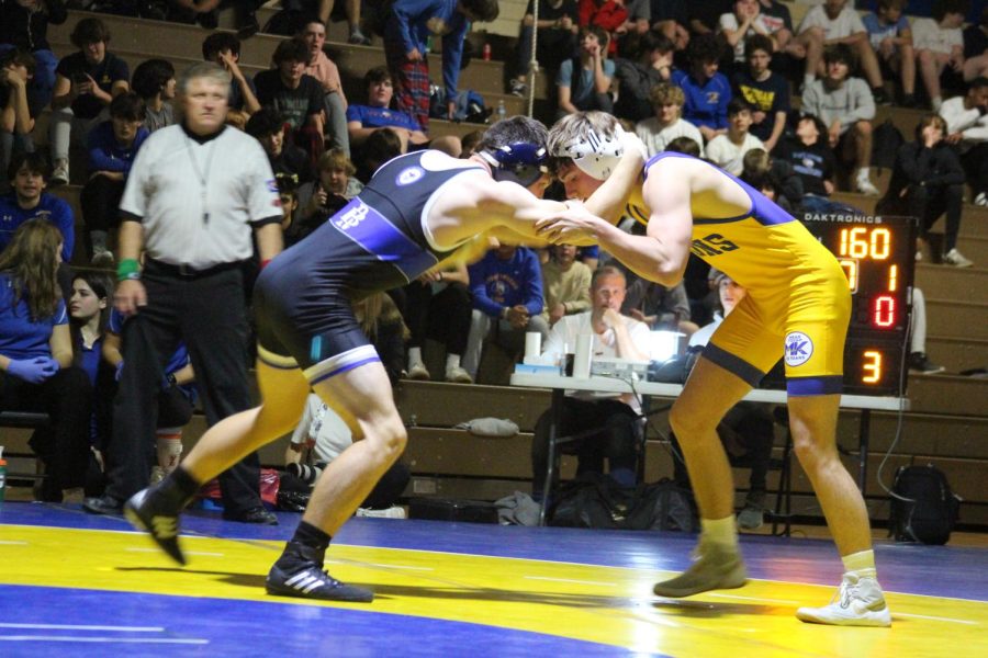 Charlie Campbell 23 locks up against Riverside-Brookfield wrestler in match on Nov. 23 in Vaughn gym (Crousore/LION)