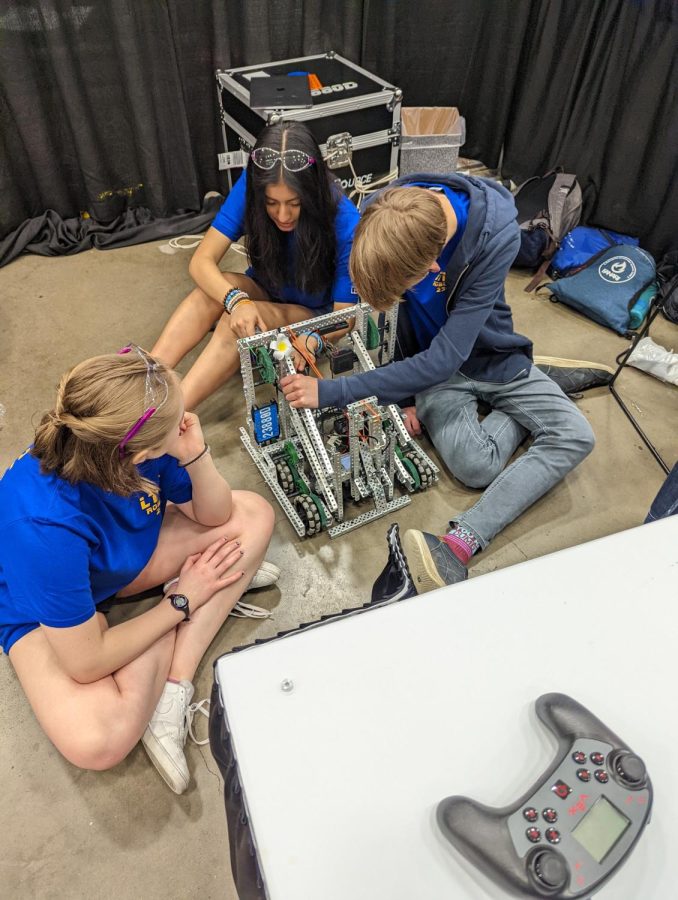 Robotics+team+members+at+the+World+Championships+last+year+fixing+their+robot+in+between+matches+%28photo+courtesy+of+Blake+Saunders%29.%0A%0A